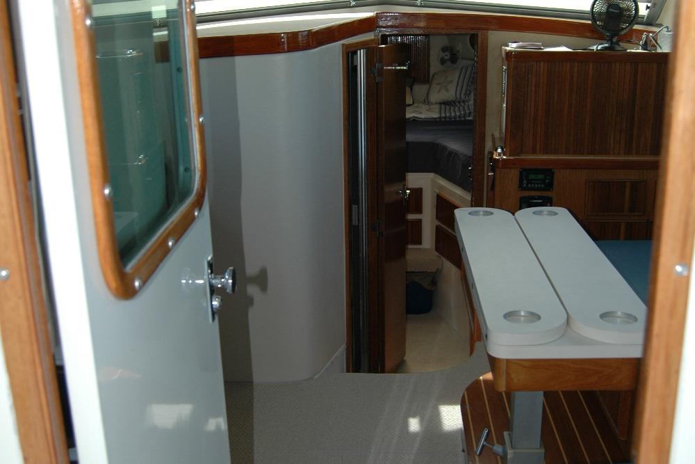 Interior view of 1987 Bertram 33 Sport Fisherman, featuring wood accents and cabin entry.