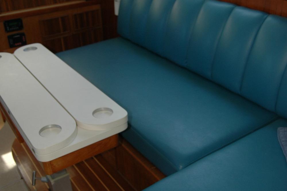 1987 Bertram 33 Sport Fisherman interior with blue seating and white table.