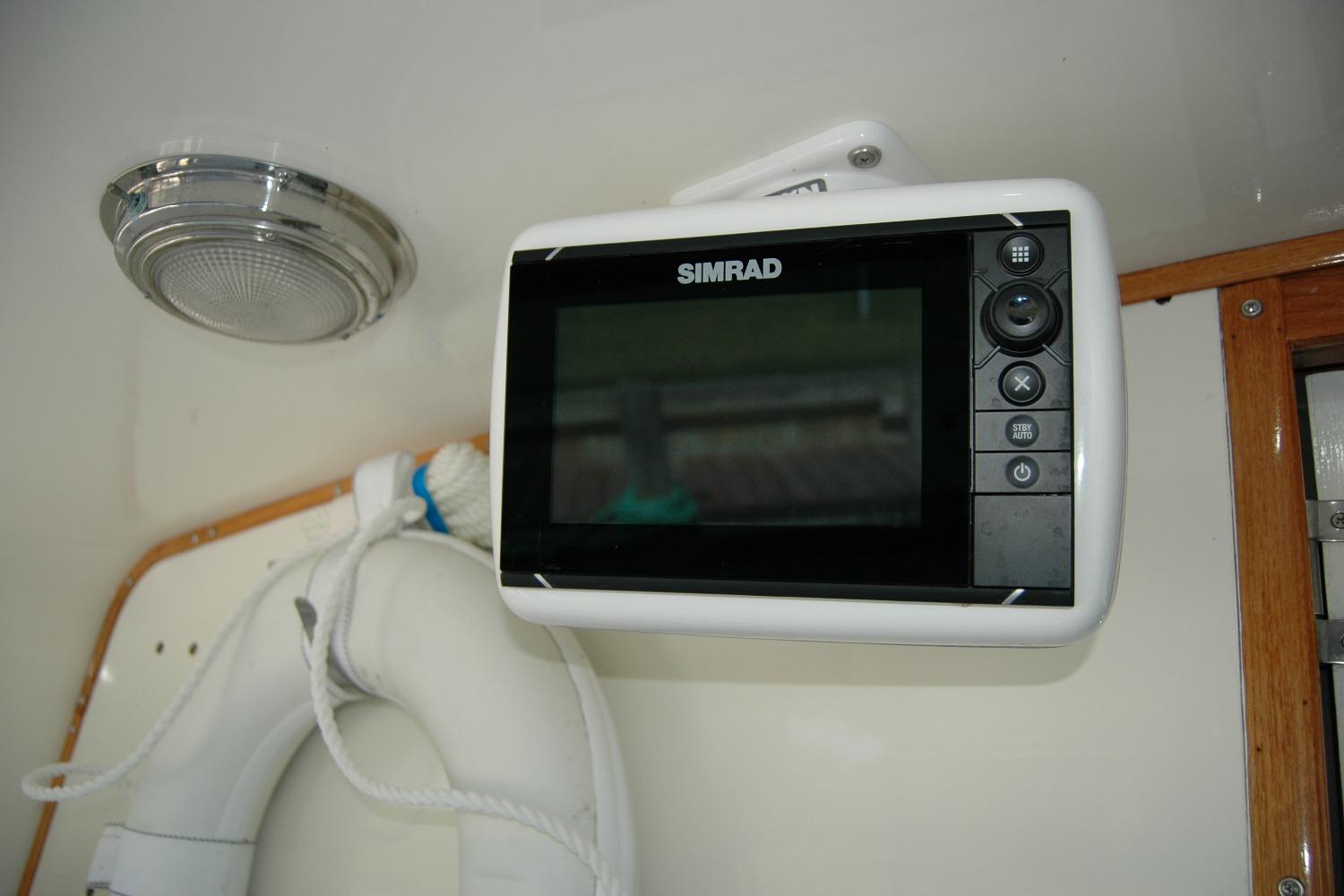 Simrad marine display on 1987 Bertram 33 Sport Fisherman boat interior.