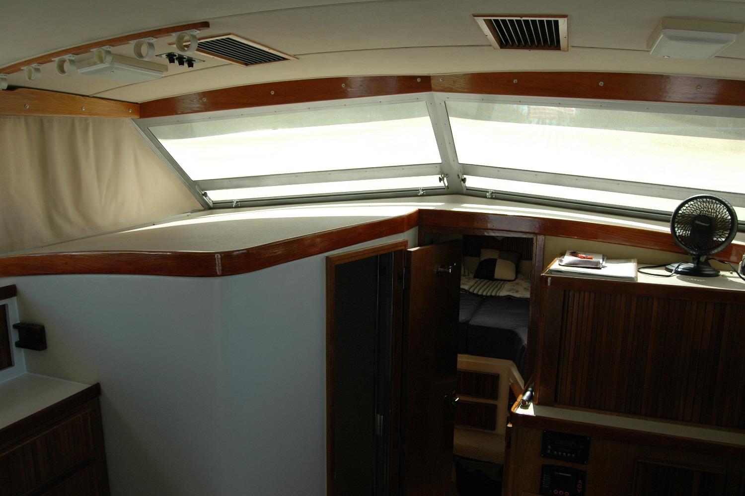 Interior of 1987 Bertram 33 Sport Fisherman with wood accents and cabin view.