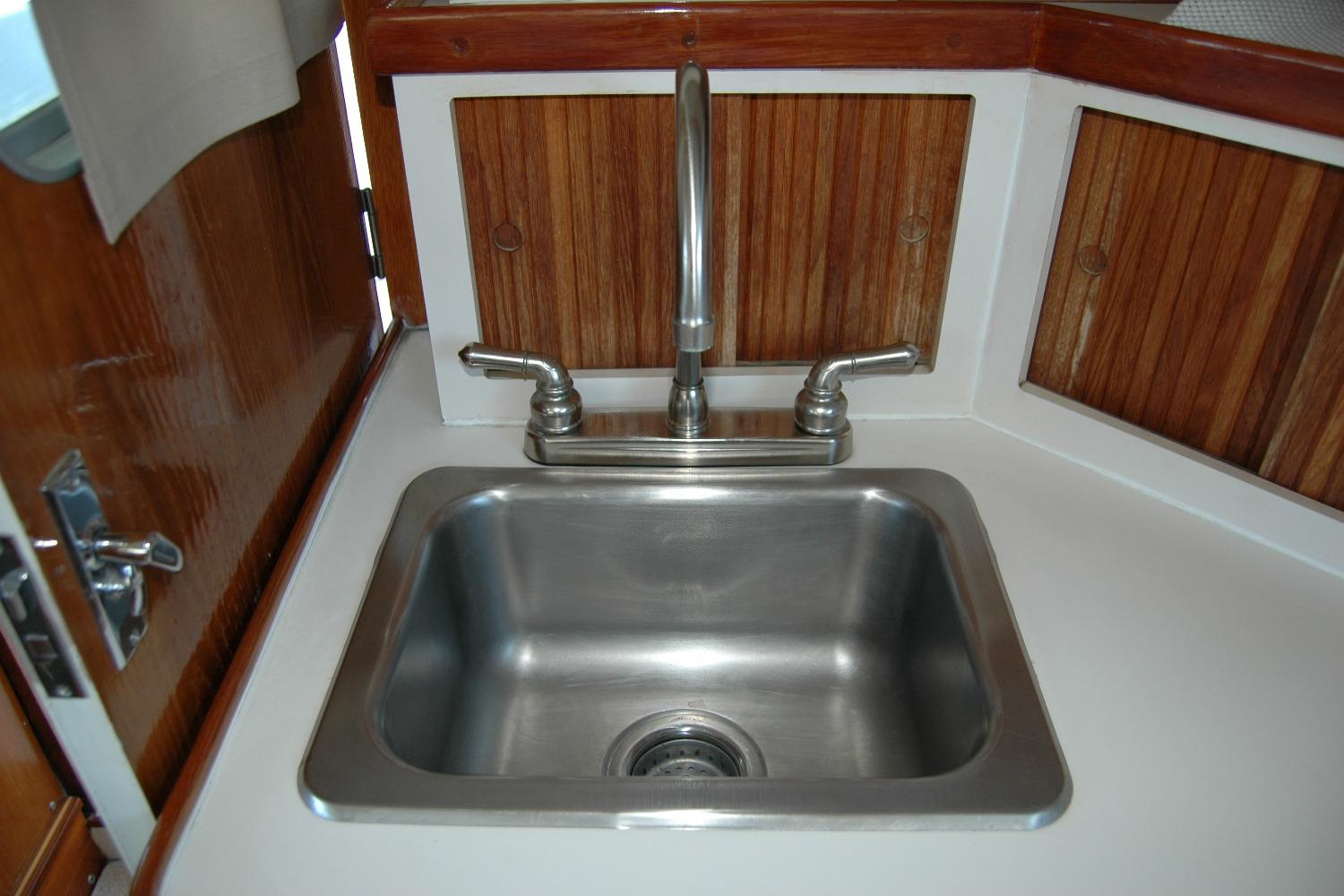 Stainless steel sink in 1987 Bertram 33 Sport Fisherman boat interior.
