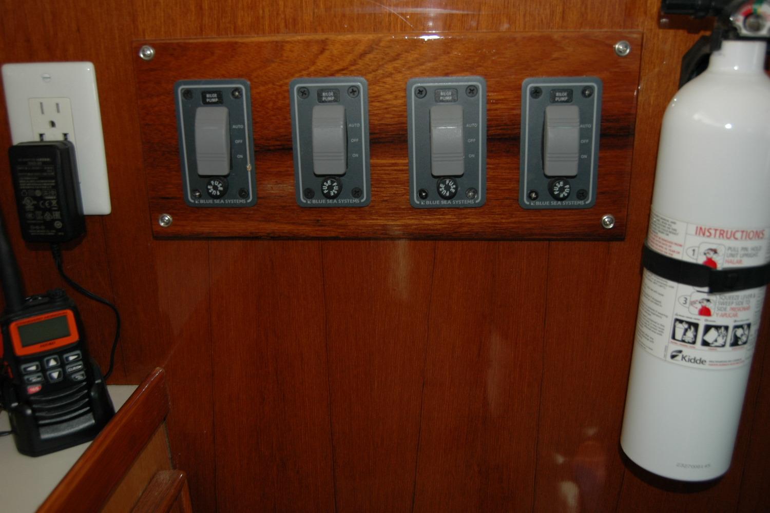 Control panel and fire extinguisher on 1987 Bertram 33 Sport Fisherman boat.