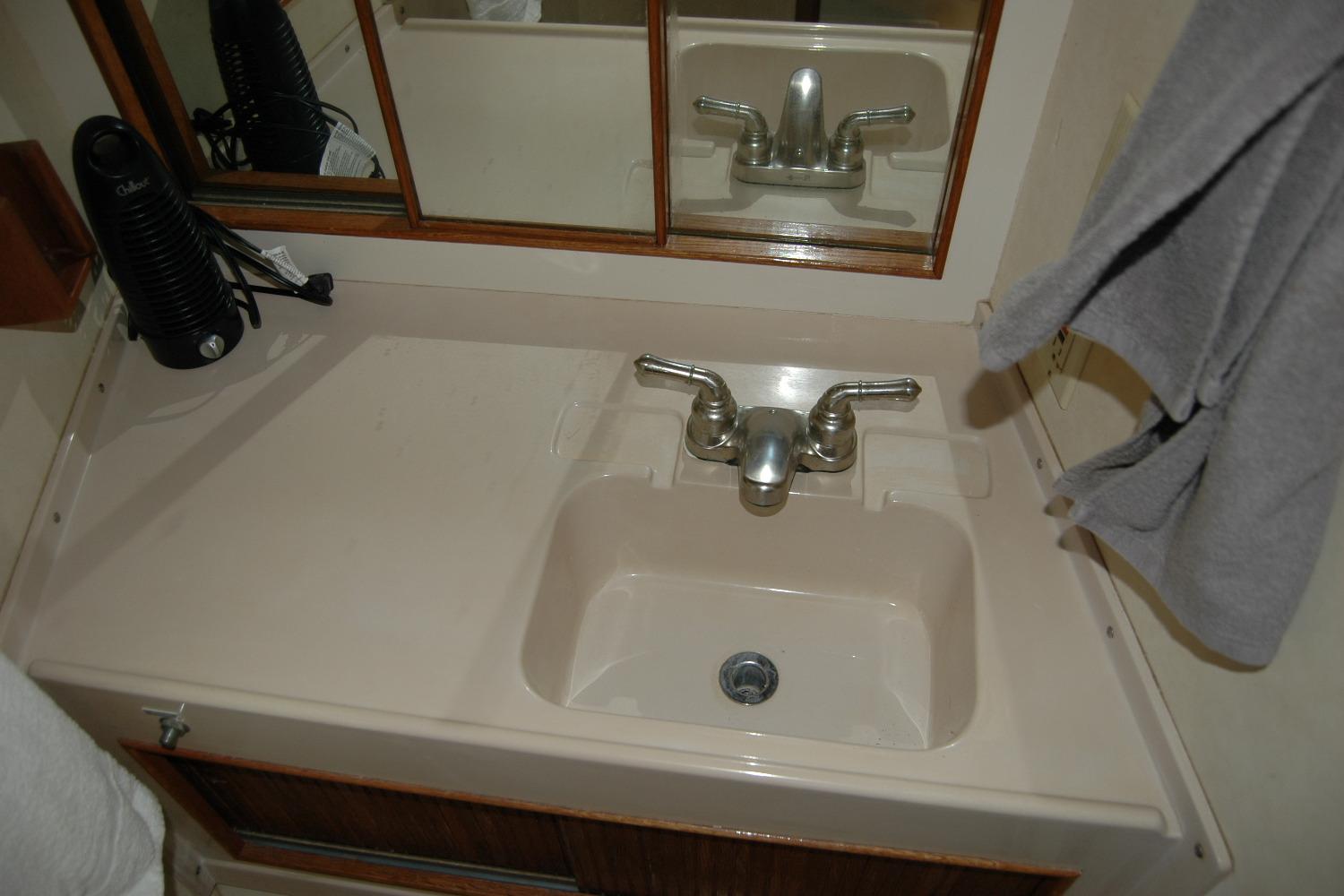 Bathroom sink area in a 1987 Bertram 33 Sport Fisherman boat.