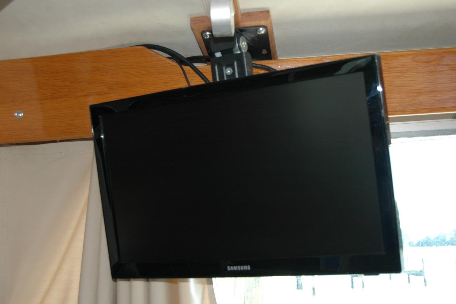 Wall-mounted Samsung TV inside 1987 Bertram 33 Sport Fisherman boat.
