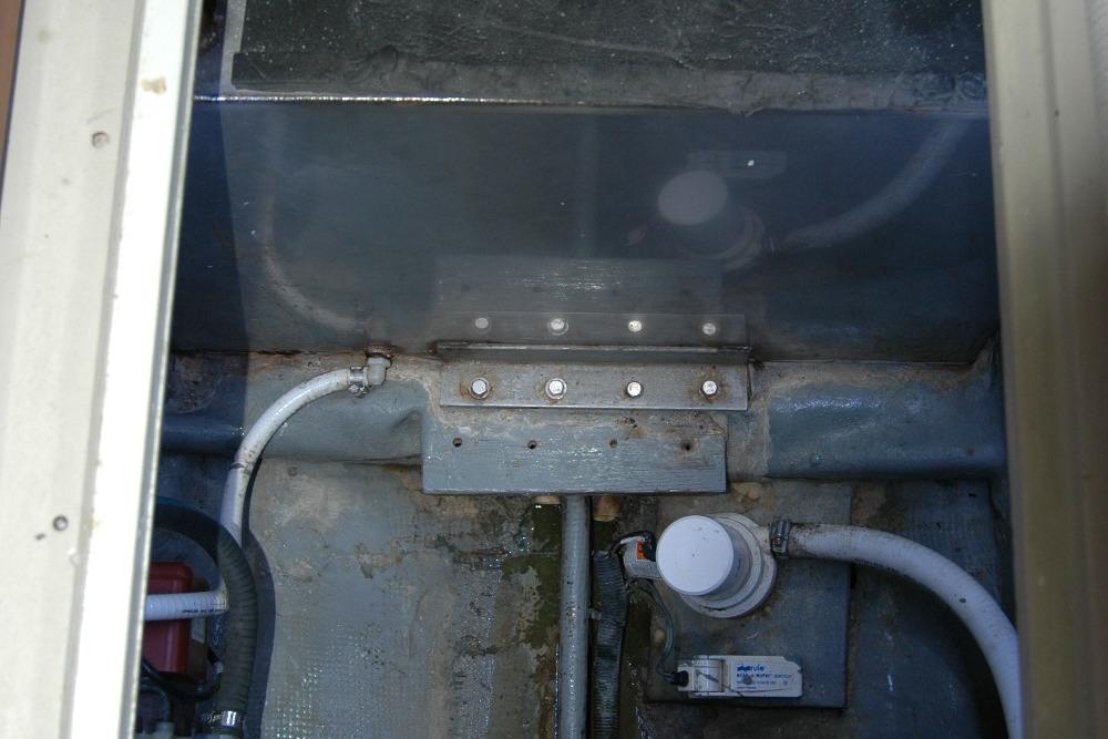 Bilge area of 1987 Bertram 33 Sport Fisherman with visible pipes and fittings.