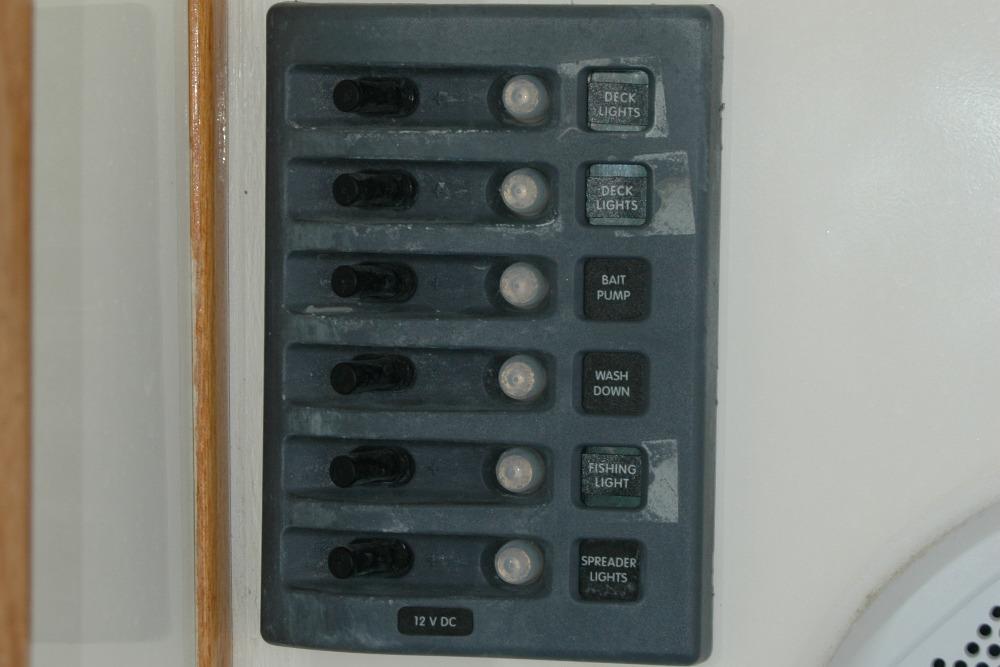 Control panel on a 1987 Bertram 33 Sport Fisherman boat with labeled switches.