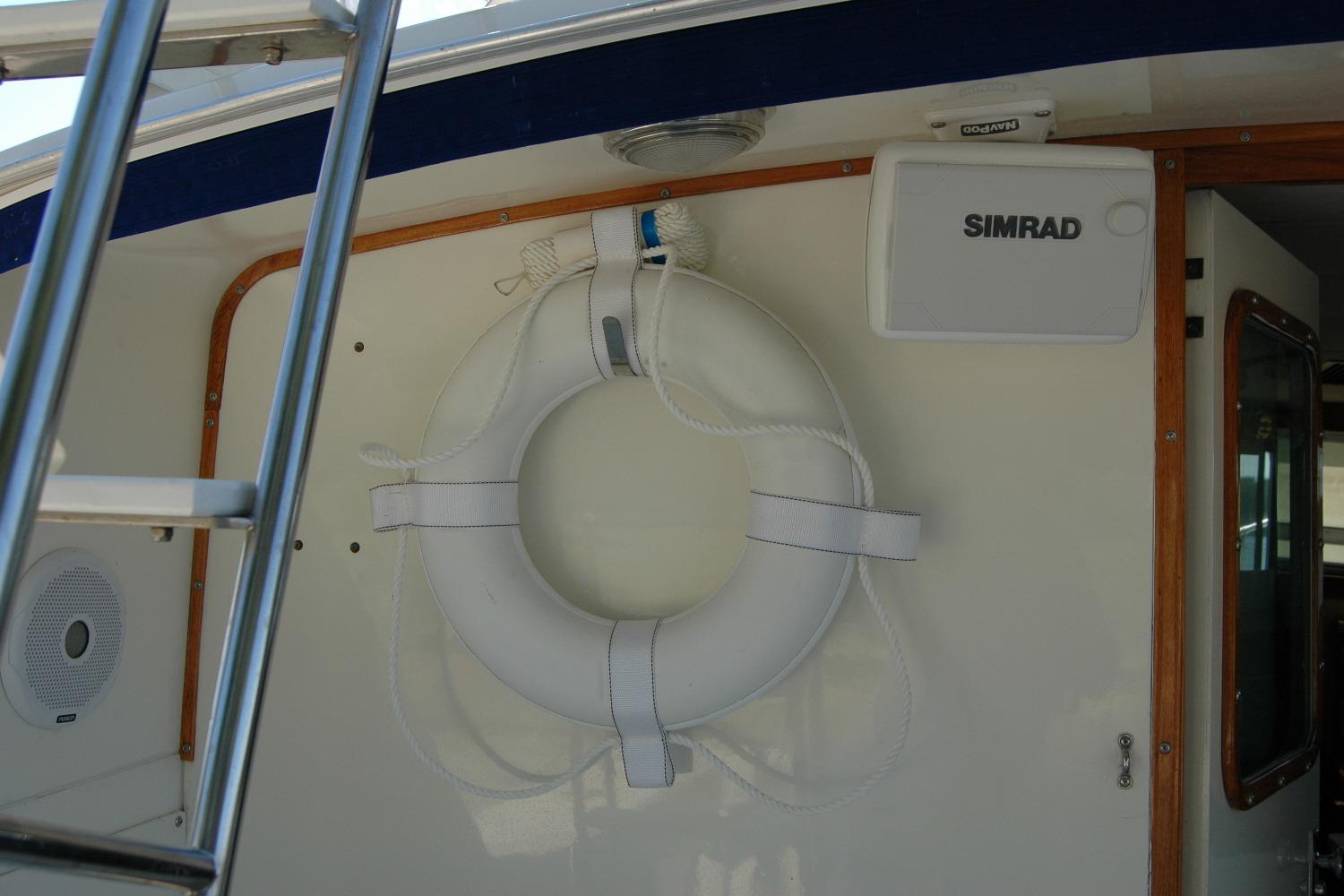 1987 Bertram 33 Sport Fisherman boat interior with life preserver and Simrad equipment.