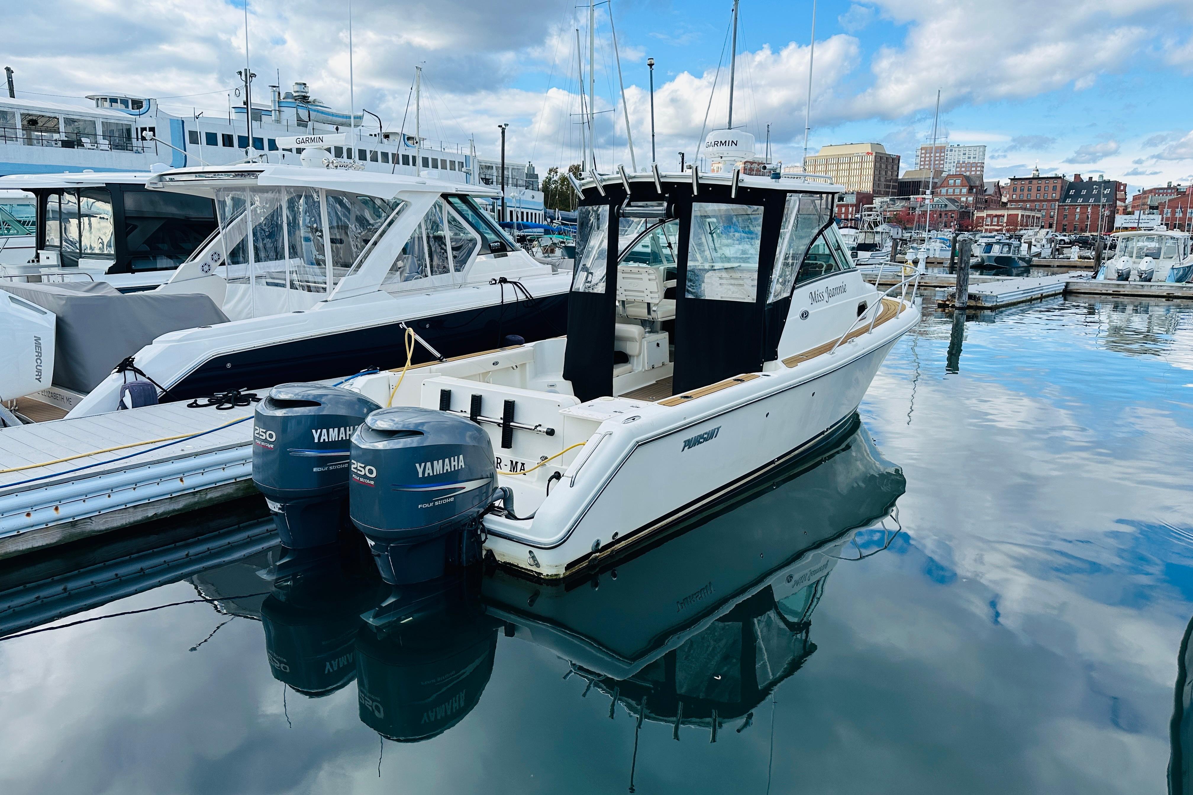 2007 Pursuit OS 285 Offshore boat docked with twin Yamaha engines.