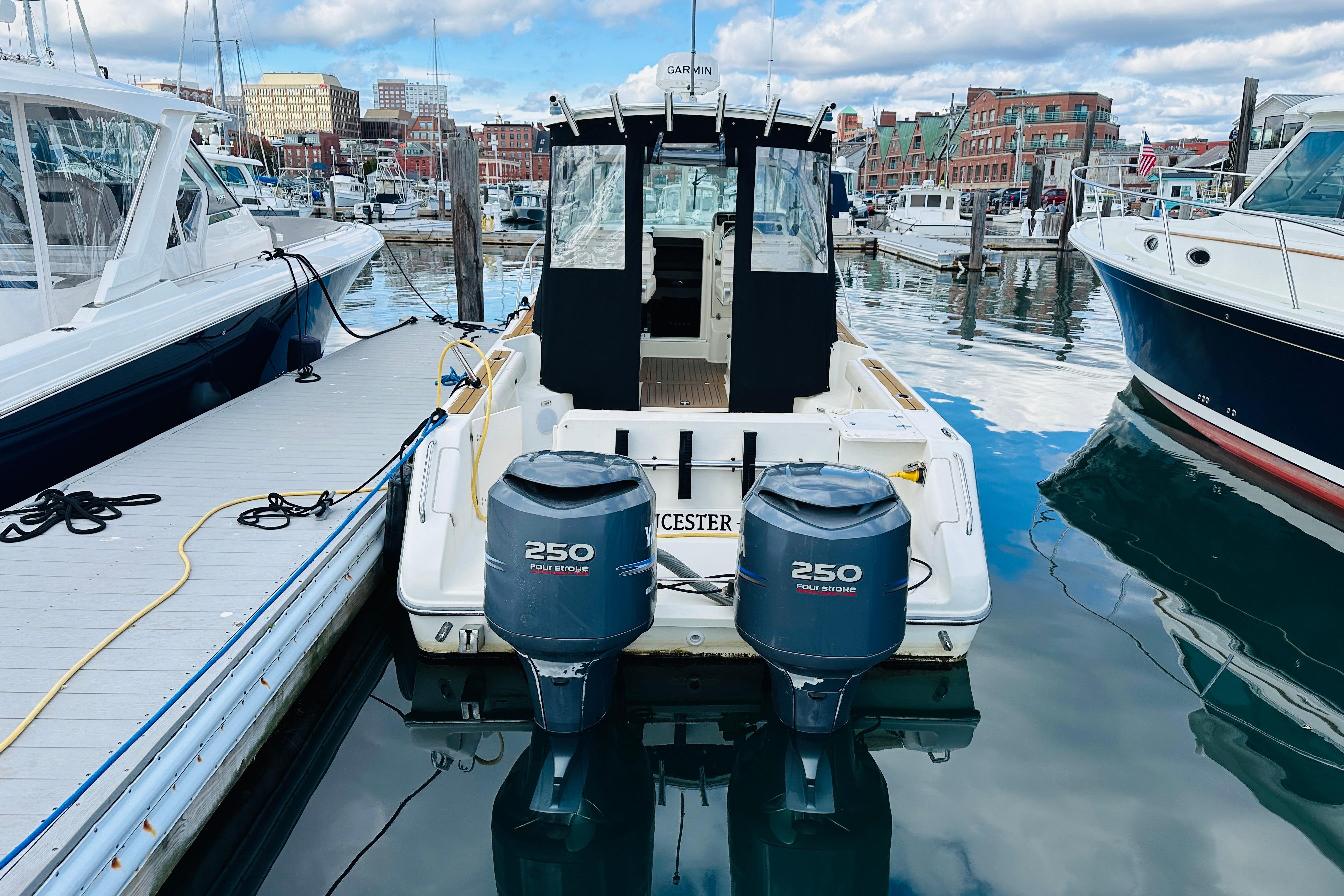 2007 Pursuit OS 285 Offshore boat docked with twin 250 horsepower engines.