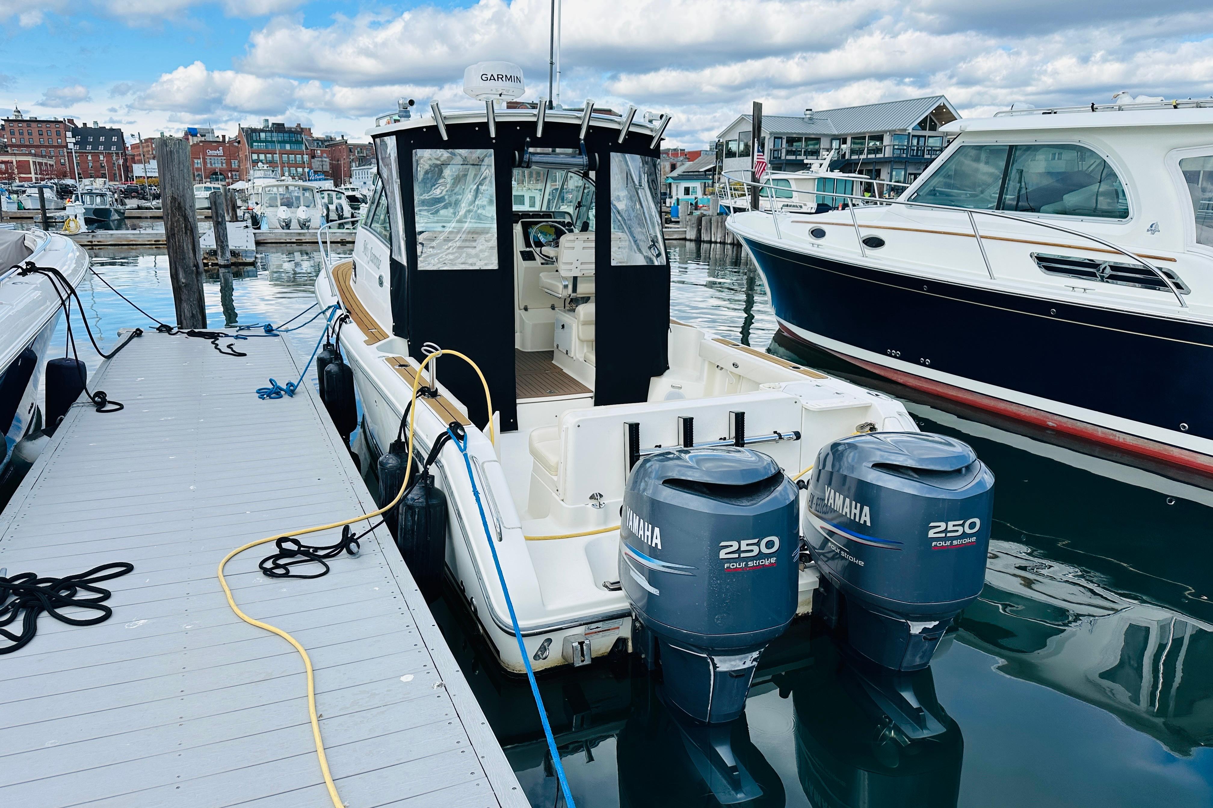 2007 Pursuit OS 285 Offshore boat docked with twin Yamaha 250 engines.