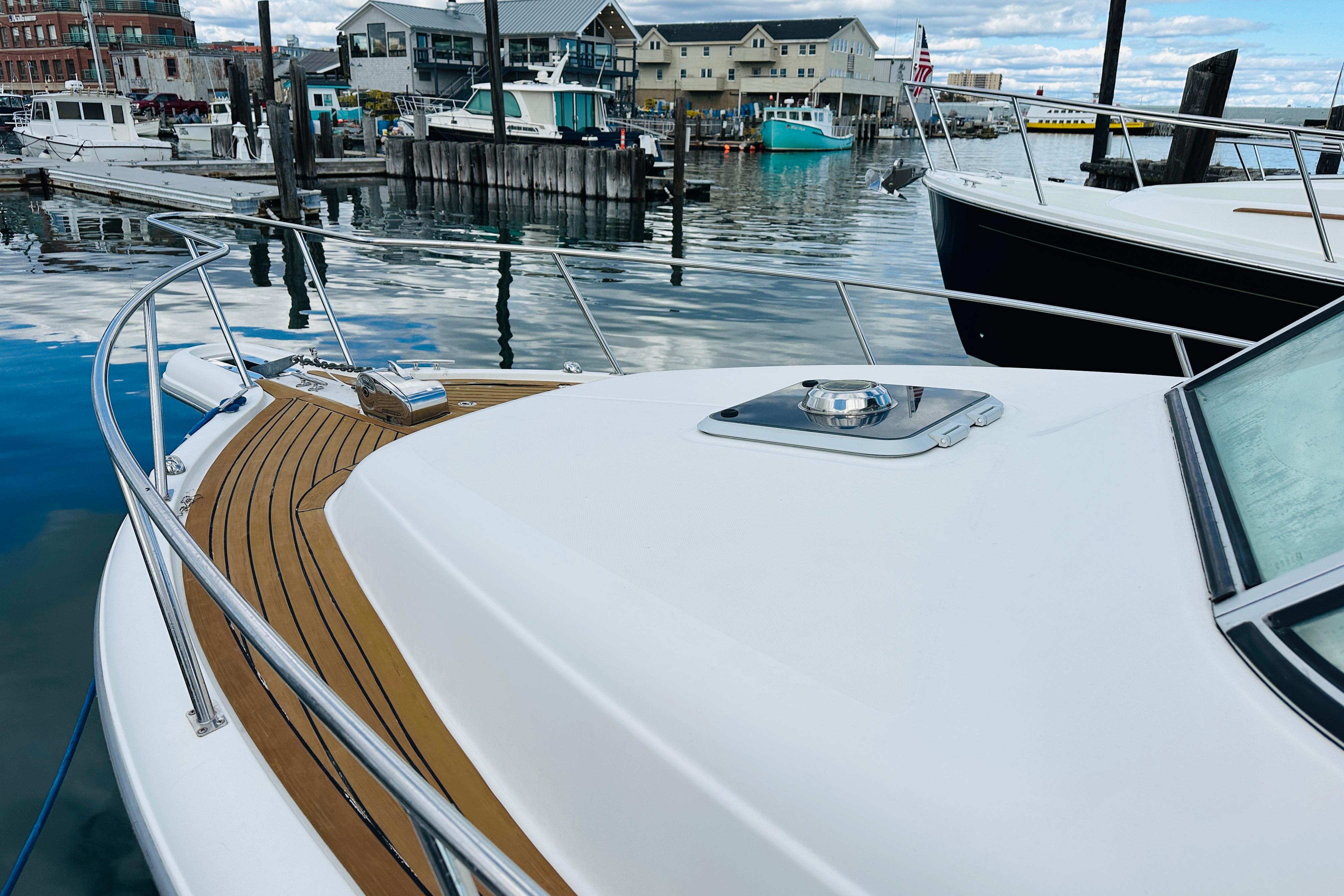 2007 Pursuit OS 285 Offshore boat docked in a marina, showcasing sleek design and wood accents.