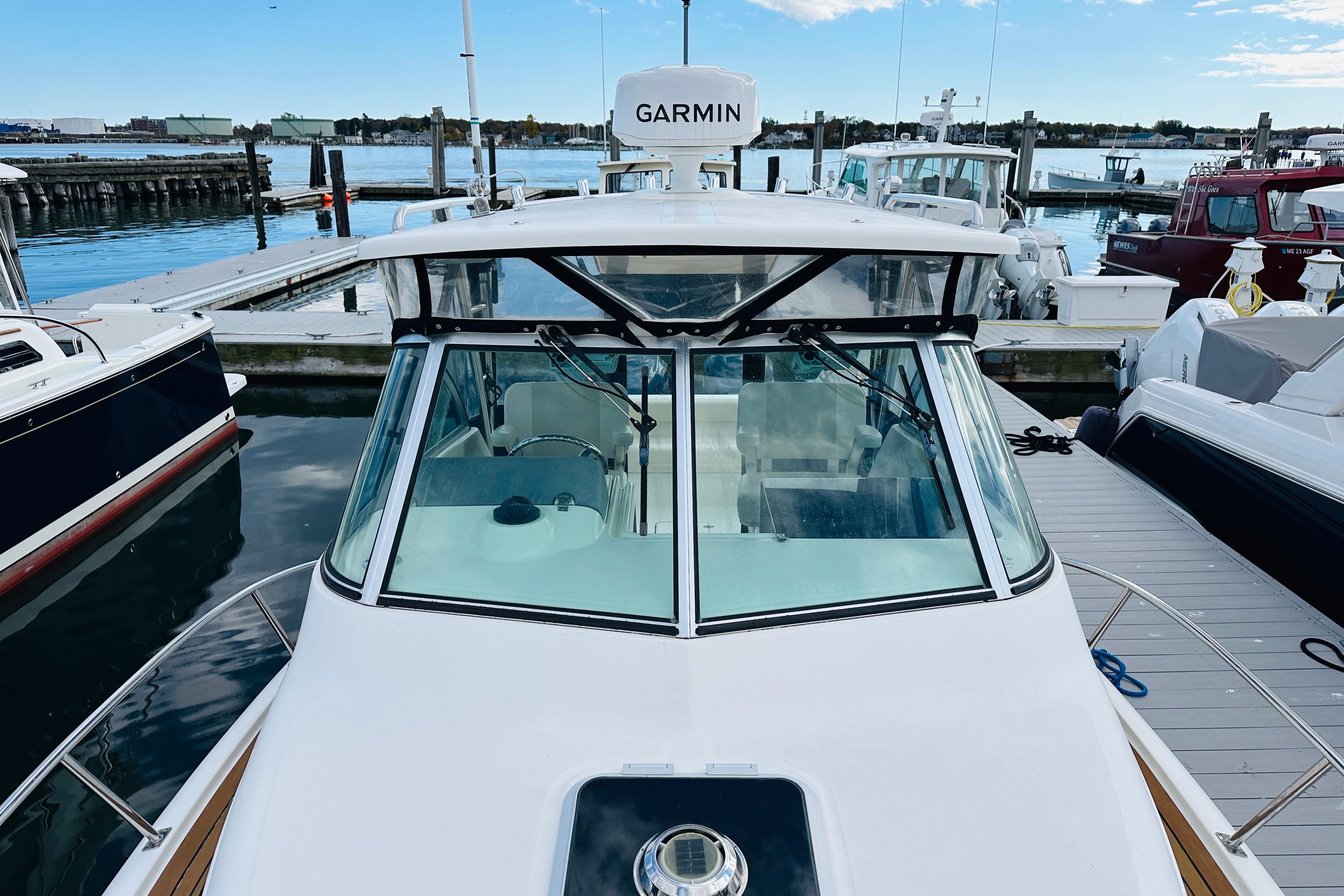 2007 Pursuit OS 285 Offshore boat docked at marina with Garmin equipment.