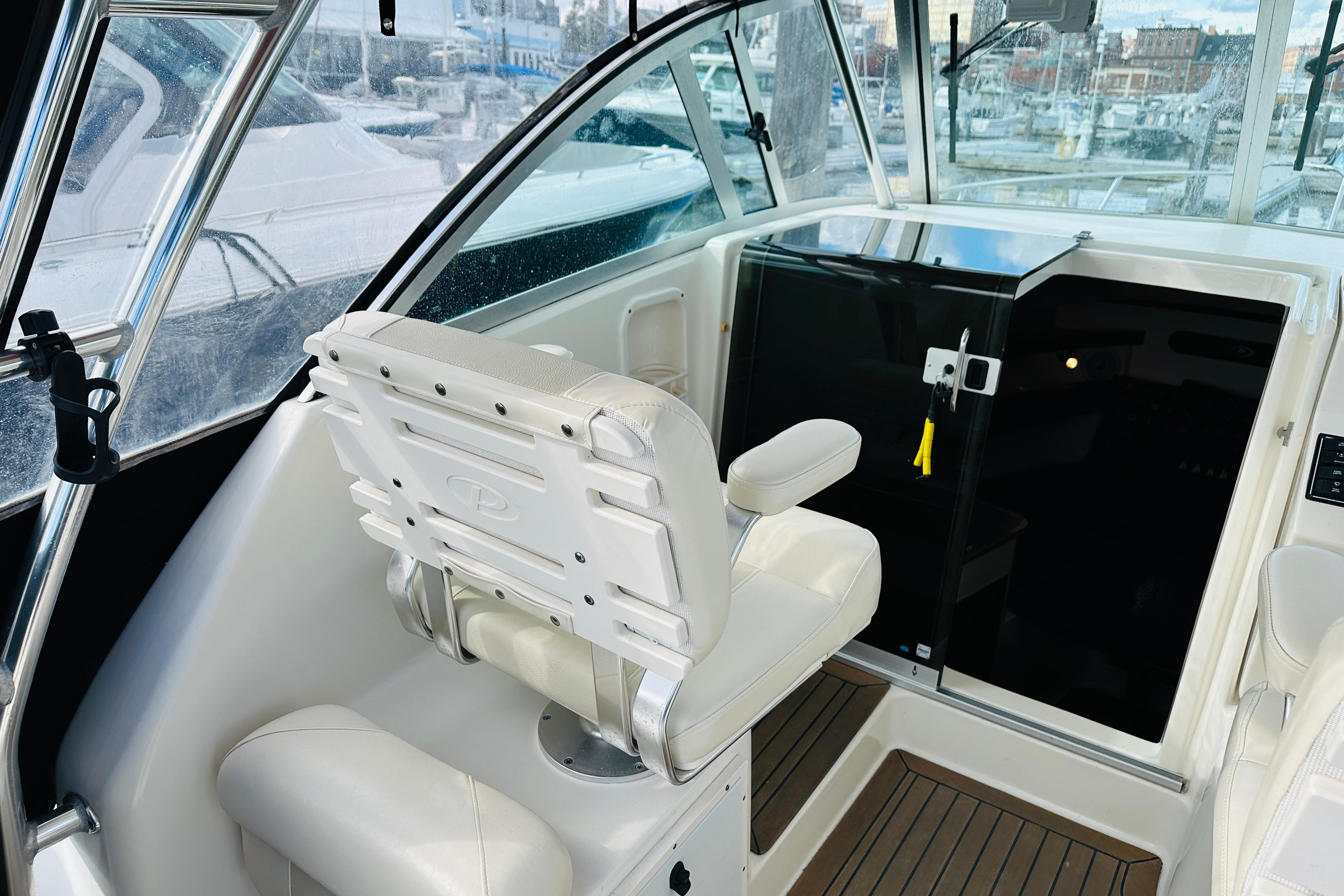 2007 Pursuit OS 285 Offshore boat interior with helm seat and cabin door.