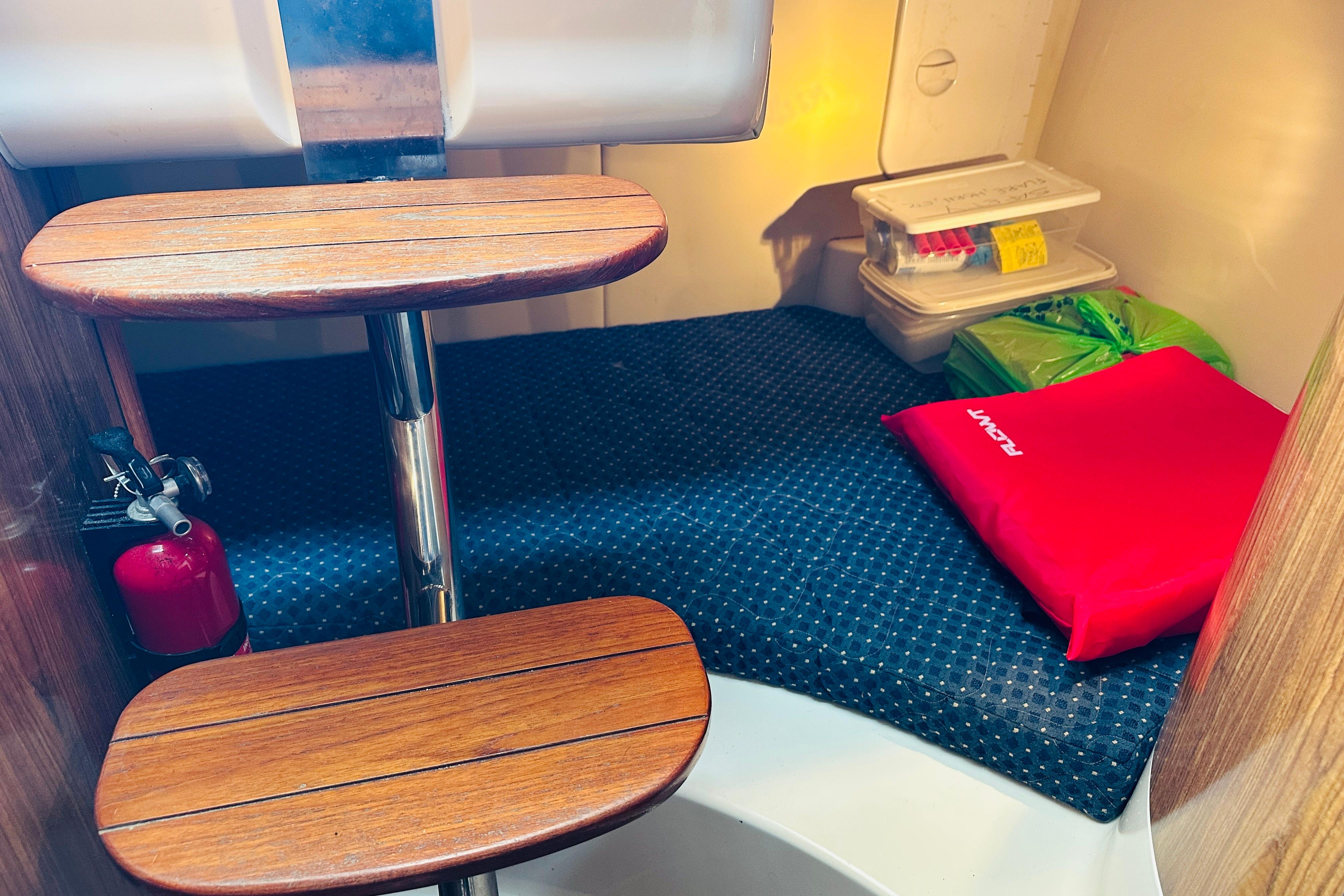 2007 Pursuit OS 285 Offshore cabin interior with wooden steps and safety equipment.