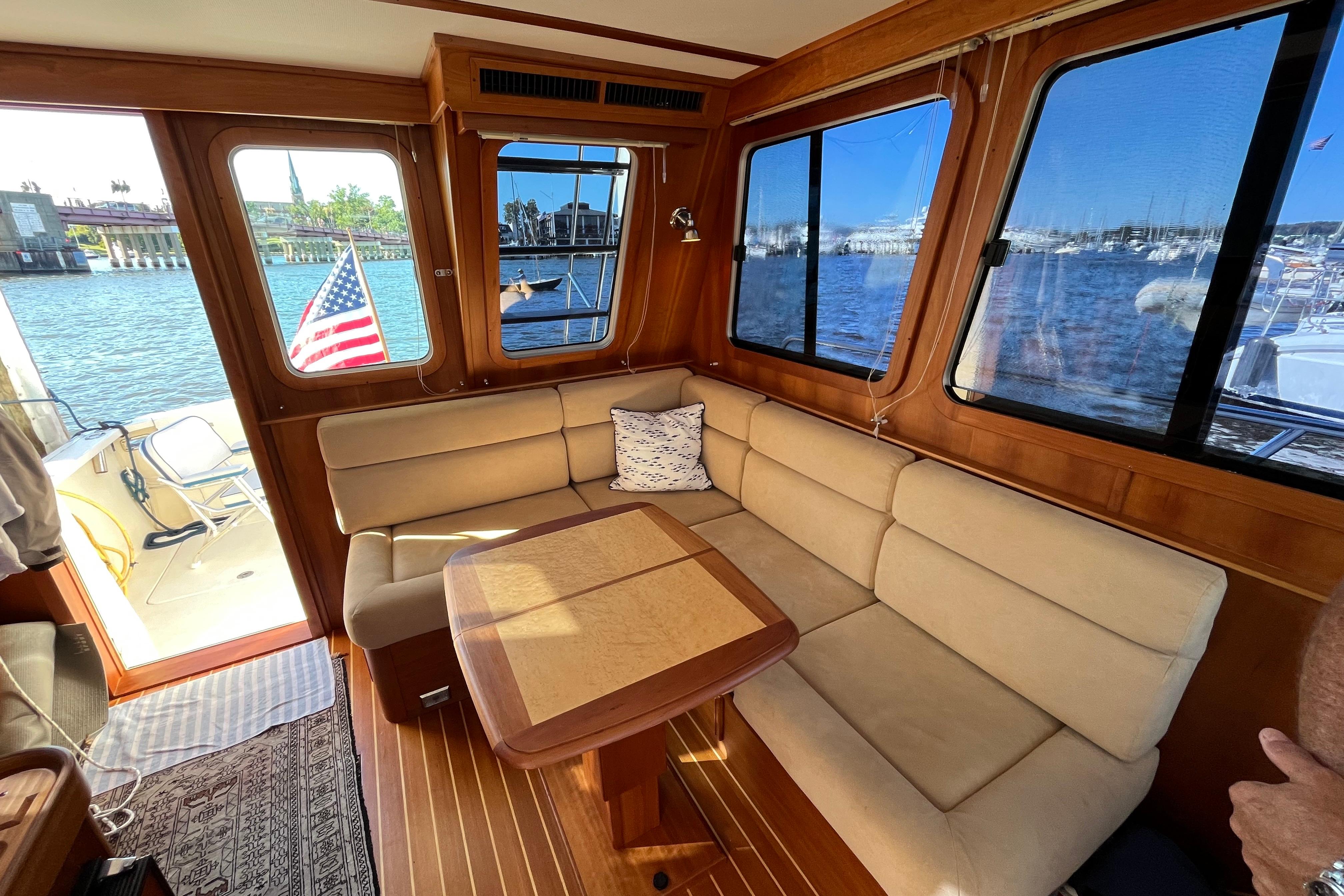 Interior of 2006 Sabre 36 Flybridge Sedan with beige seating and waterfront view.