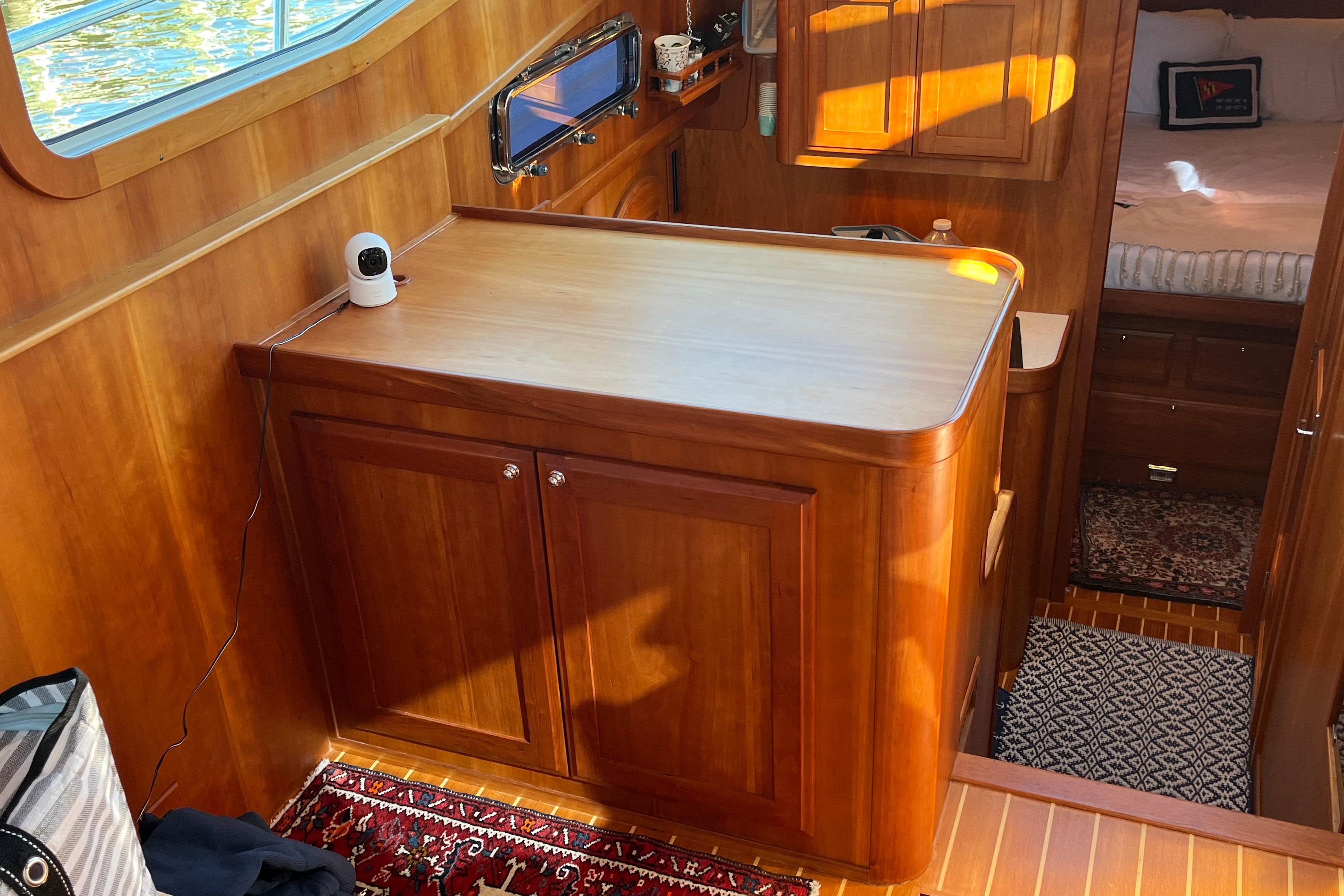 Interior of 2006 Sabre 36 Flybridge Sedan with wooden cabinetry and cozy bedroom.