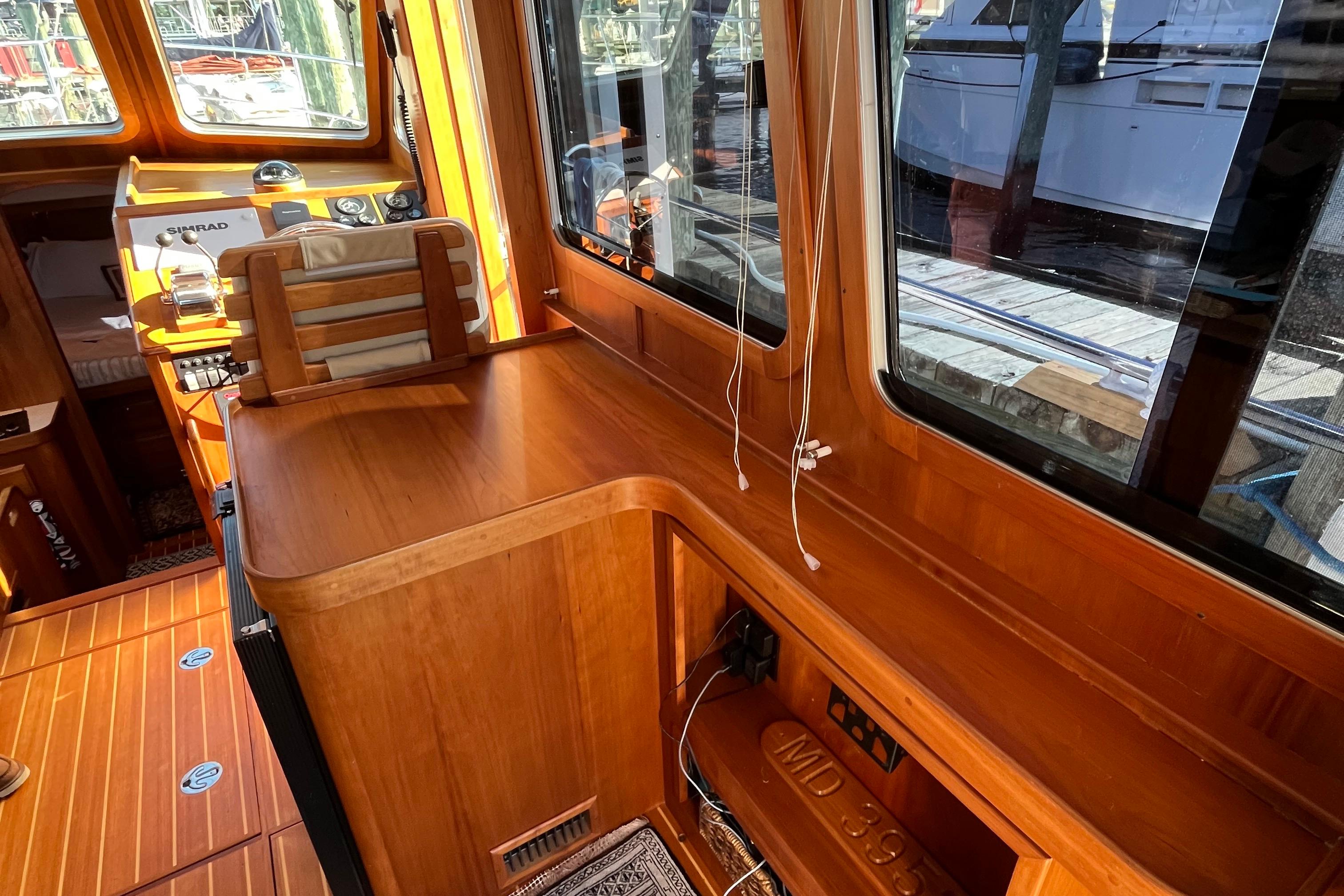 Interior of 2006 Sabre 36 Flybridge Sedan with wooden finish and helm station.