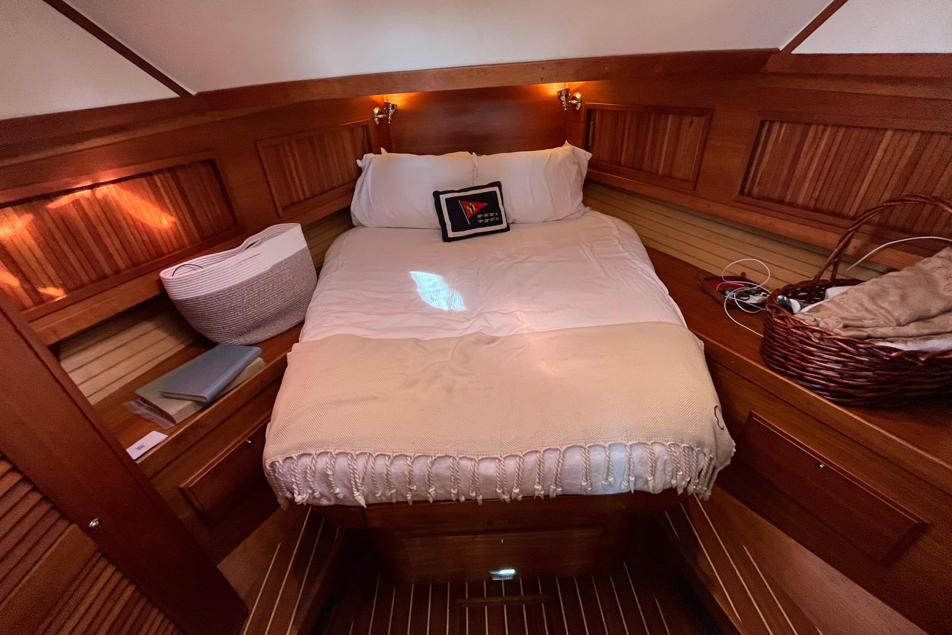 Cozy cabin interior of 2006 Sabre 36 Flybridge Sedan with wooden accents and comfortable bedding.