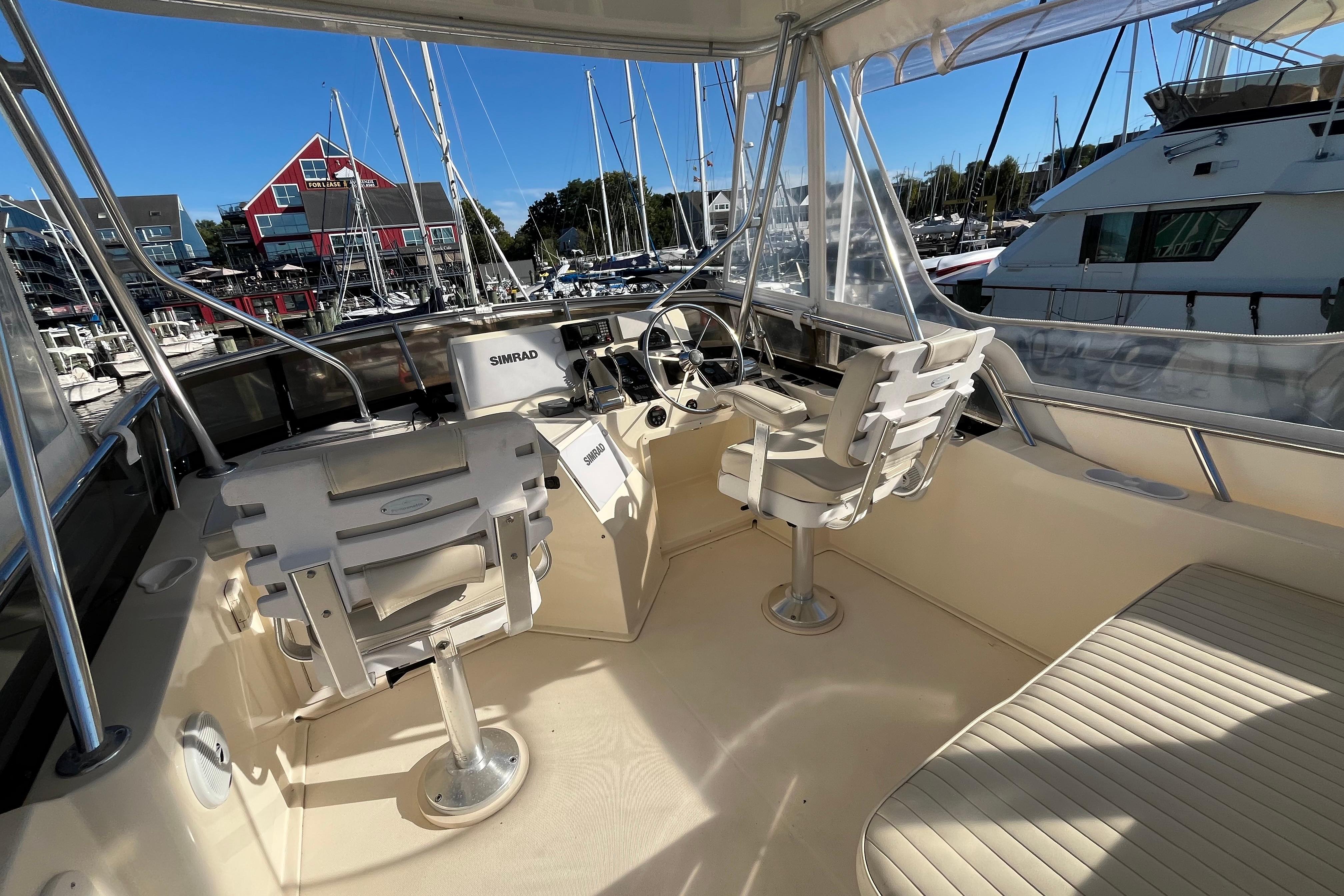 2006 Sabre 36 Flybridge Sedan interior with helm, seating, and marina view.