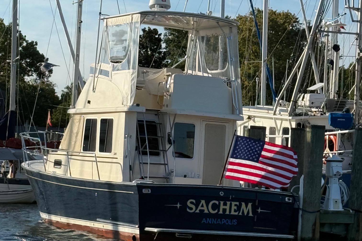 2006 Sabre 36 Flybridge Sedan docked with American flag, Annapolis.