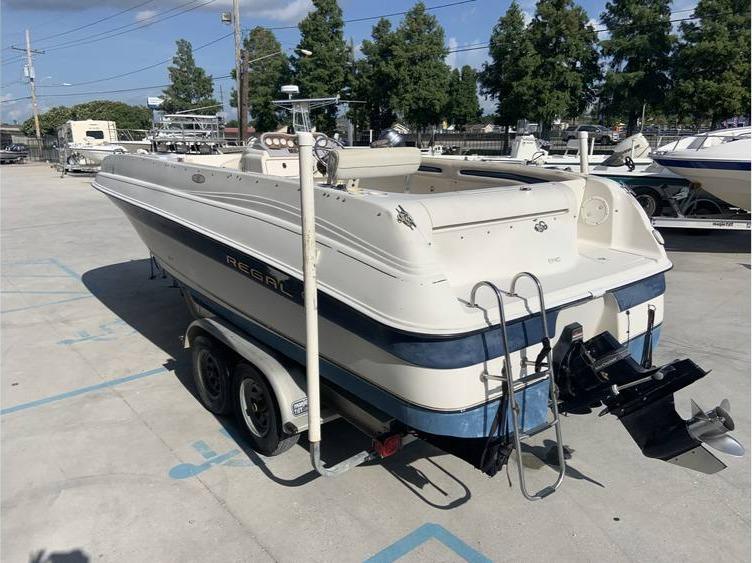 1997 Regal 200 DESTINY boat on a trailer in a marina.