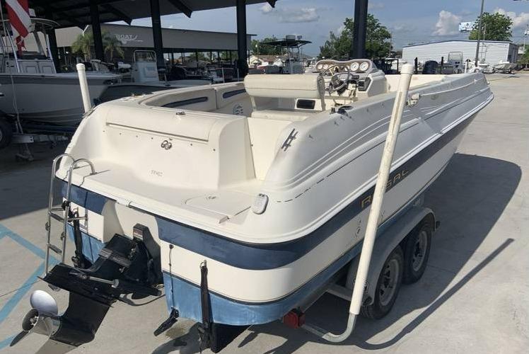 1997 Regal 200 DESTINY boat on a trailer in a marina.