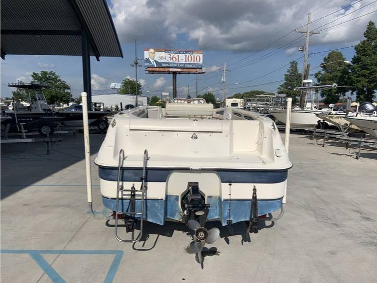 1997 Regal 200 DESTINY boat in a marina parking lot.
