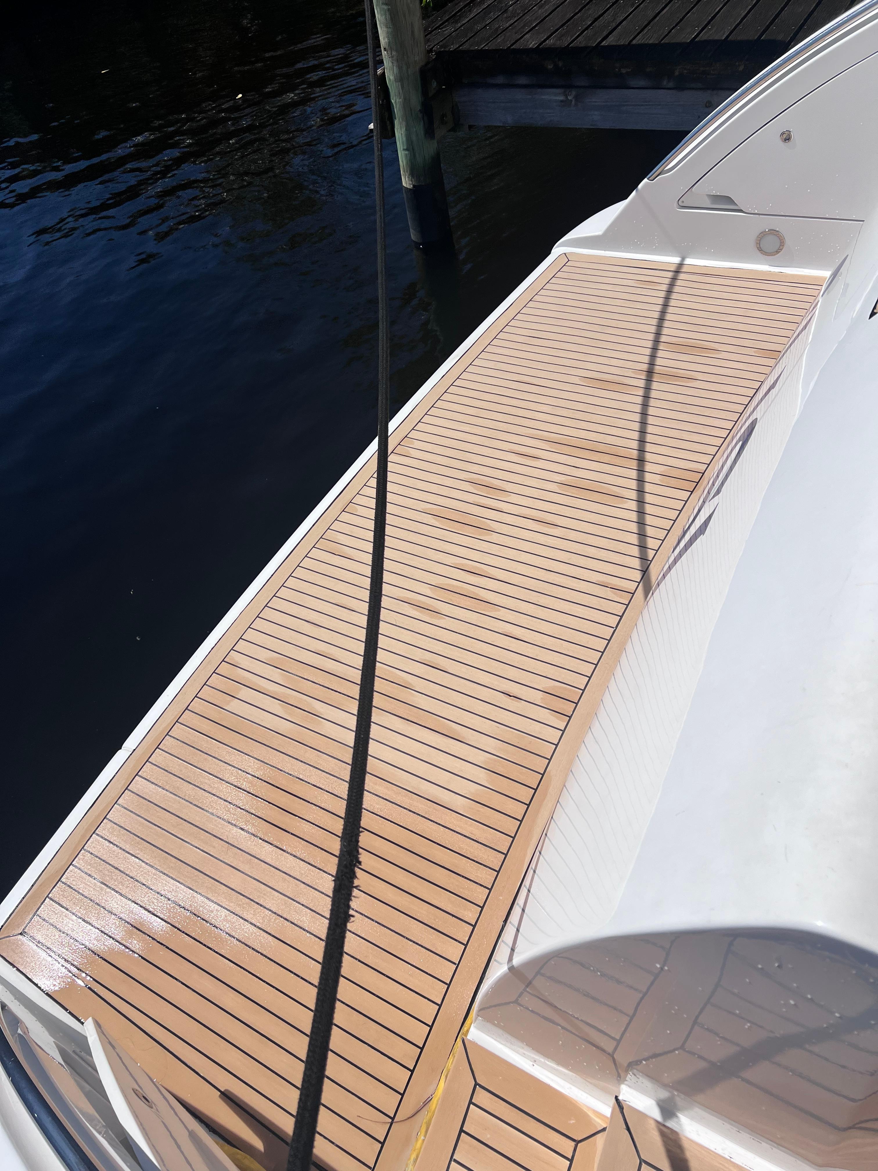 Azimut-55 flybridge 2005-Susi FL-US-2005 Azimut 55 Flybridge yacht deck with wooden finish by the water.-9213395 | Thumbnail