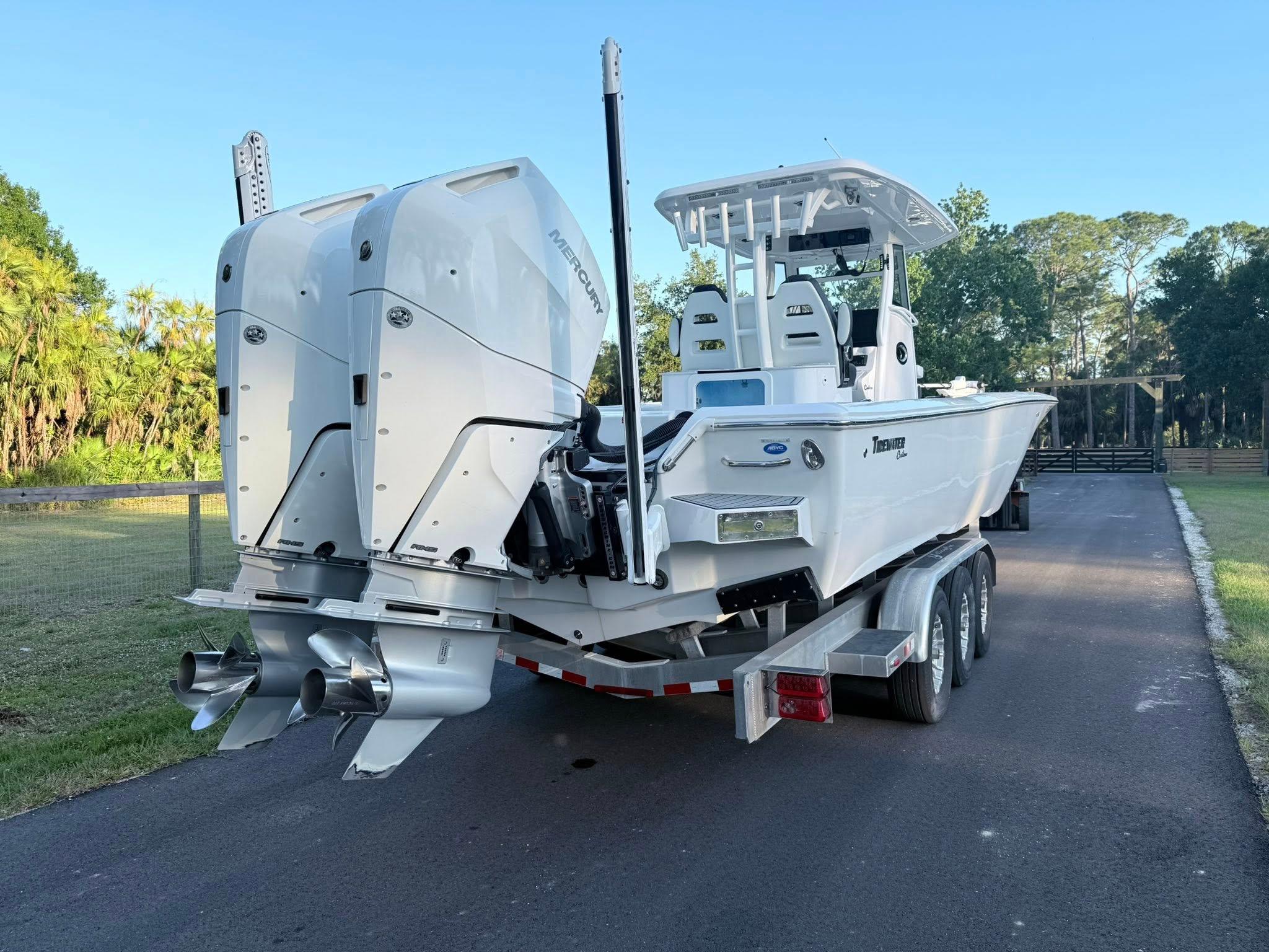 Tidewater-3100 Carolina Bay 2025 -FL-US-2025 Tidewater 3100 Carolina Bay boat on trailer, dual engines, parked outdoors.-9803417