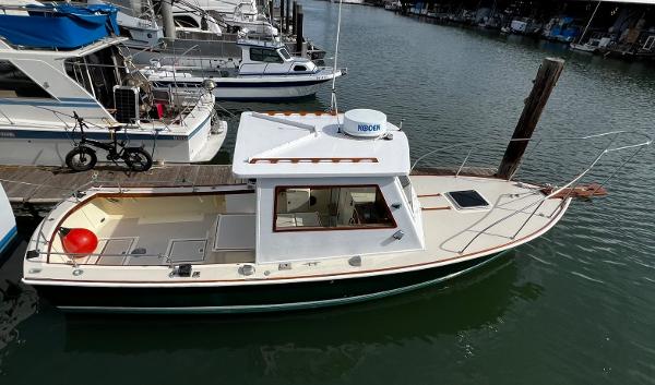 1974 Dyer 29' Sport Fisher boat docked in marina, side view.