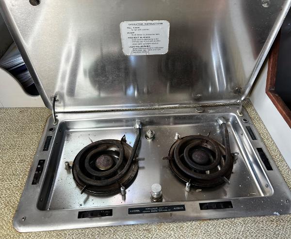 Stainless steel two-burner stove on a 1974 Dyer 29' Sport Fisher boat.