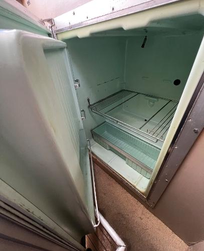 Open refrigerator inside a 1974 Dyer 29' Sport Fisher boat.