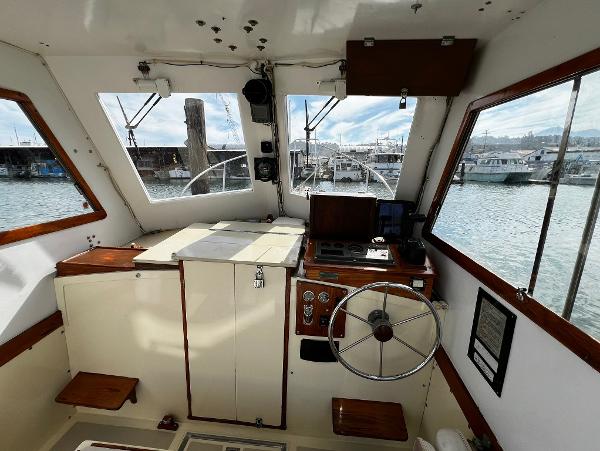 Interior view of a 1974 Dyer 29' Sport Fisher boat with steering wheel and control panel.
