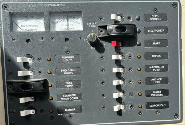 Control panel of a 1974 Dyer 29' Sport Fisher boat with various switches and gauges.