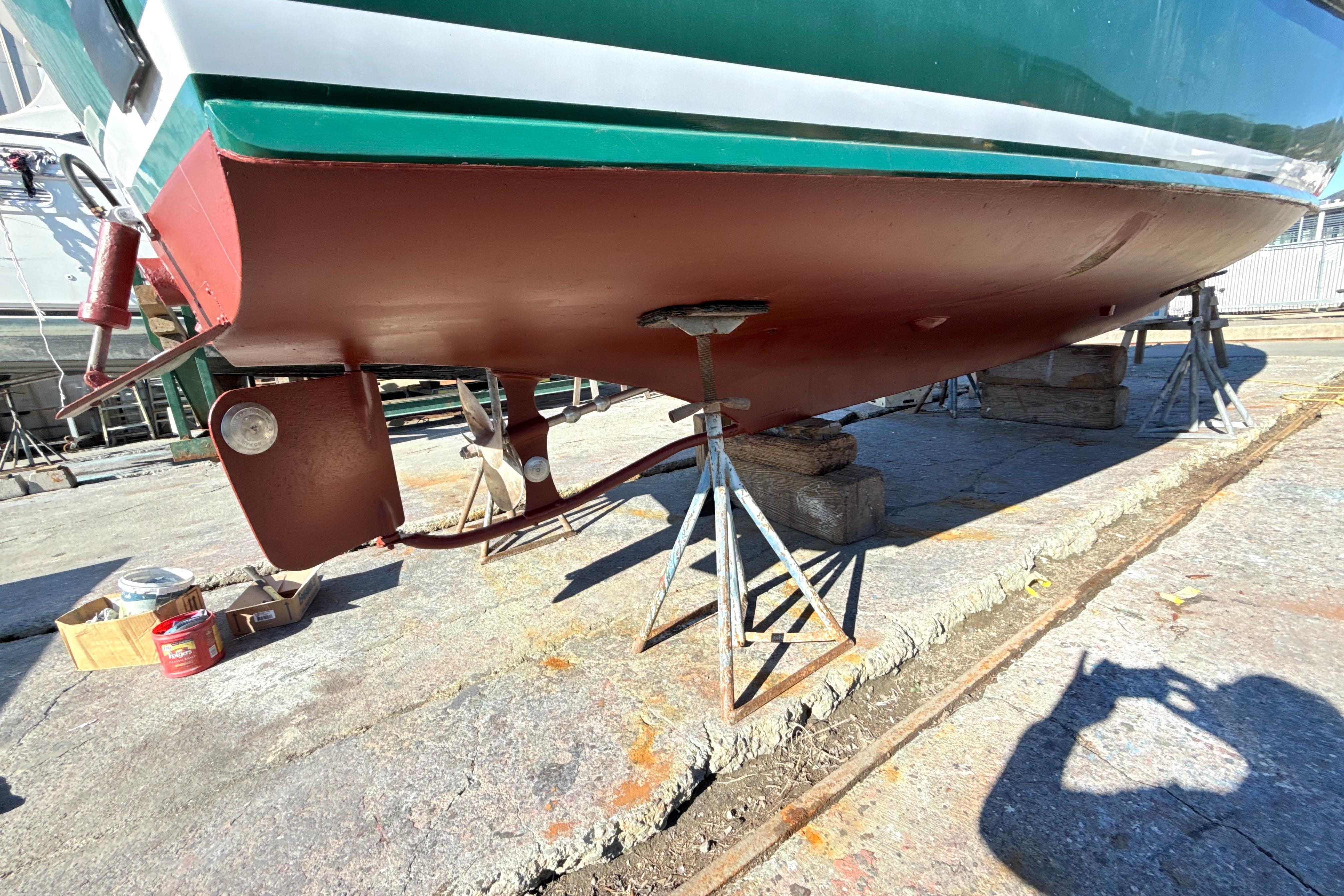 1974 Dyer 29' Sport Fisher boat on stands, showing hull and propeller.