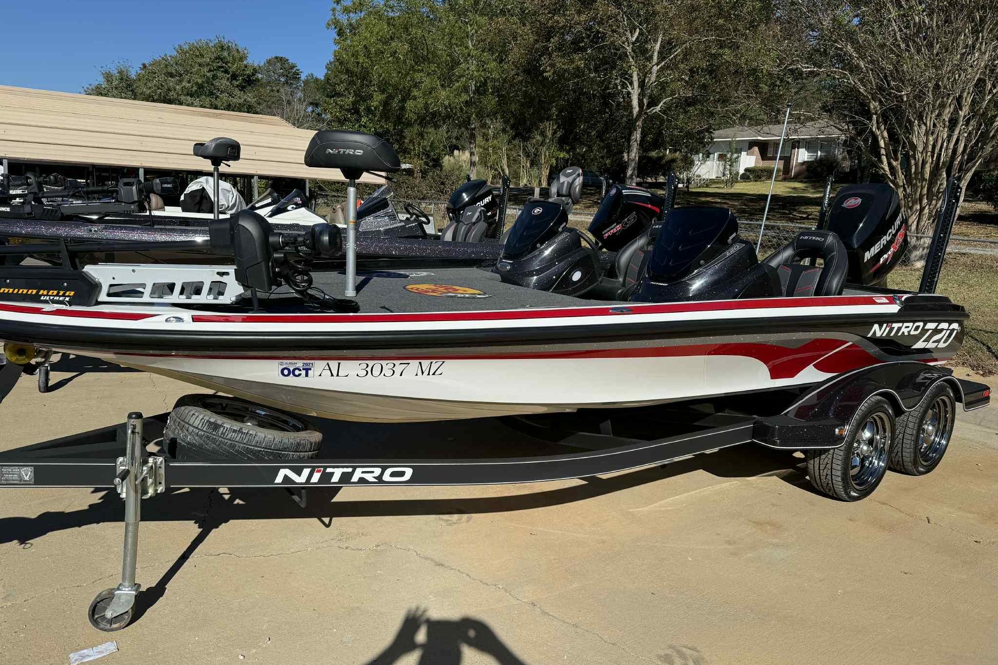 2017 Nitro Z20 Pro boat on trailer, parked outdoors, with visible registration number.
