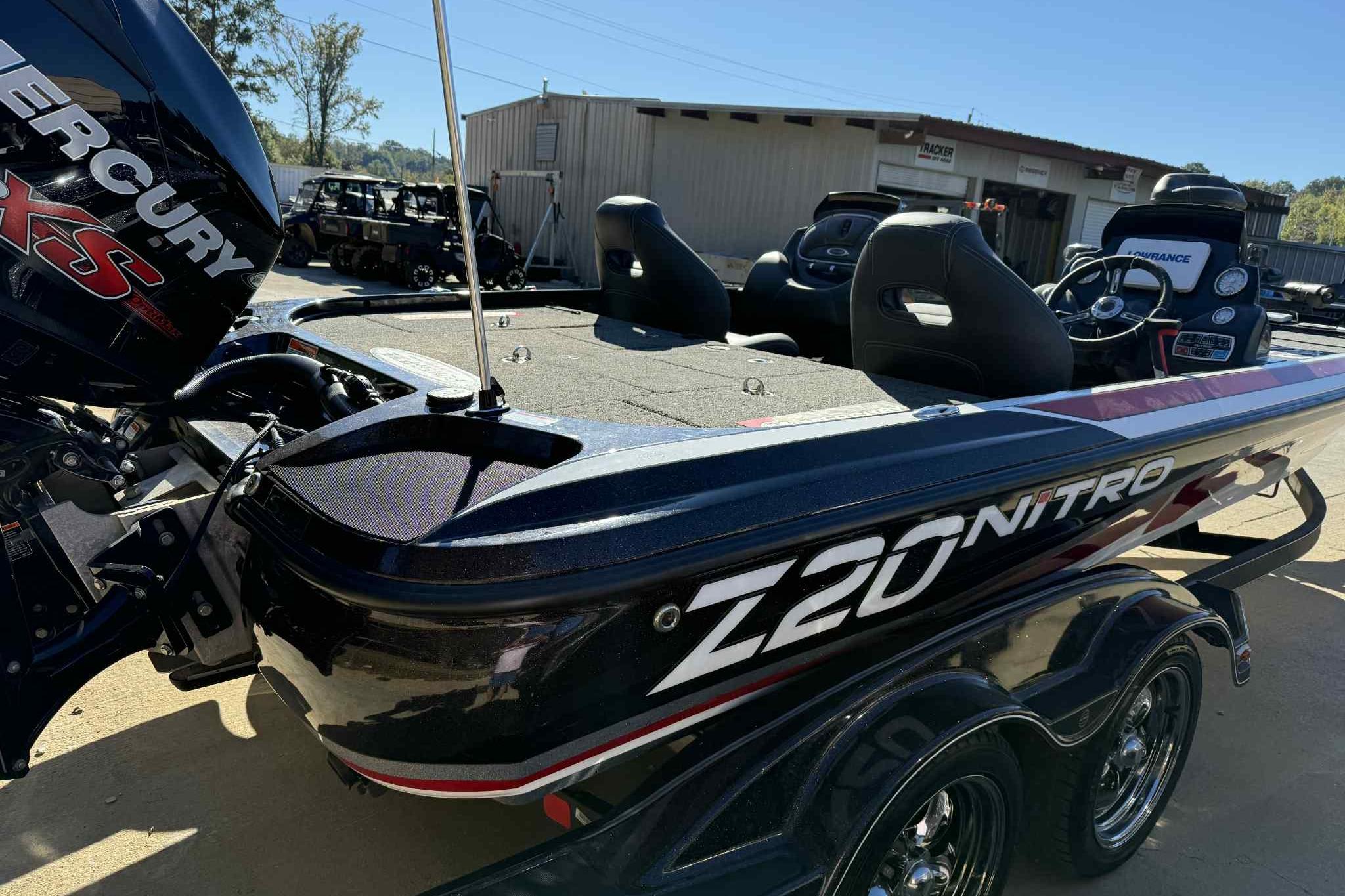 2017 Nitro Z20 Pro boat with Mercury engine, parked outdoors near a building.