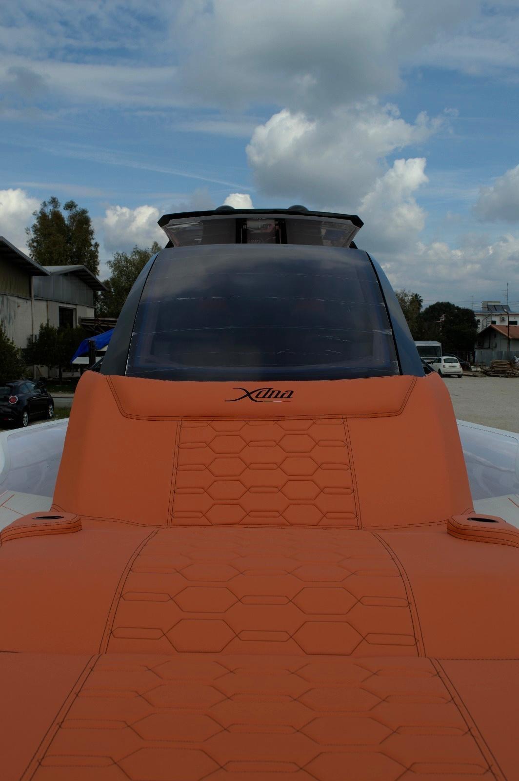DNA-46 2026 -FL-US-Futuristic DNA 46 model boat with orange seating, 2025 design, under a cloudy sky.-9703461 | Thumbnail