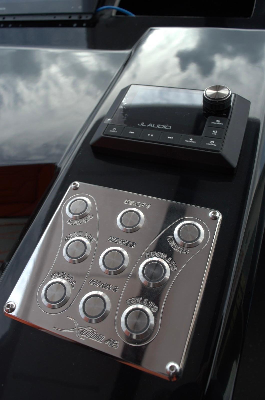 DNA-46 2026 -FL-US-Control panel and audio system on DNA 46, 2025 model, featuring sleek metallic buttons.-9703461 | Thumbnail