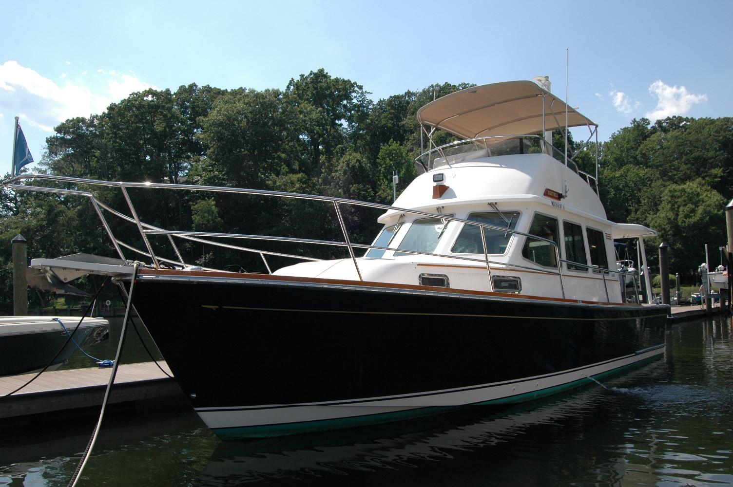 2006 Sabre 36 Flybridge Sedan docked in a serene marina setting.