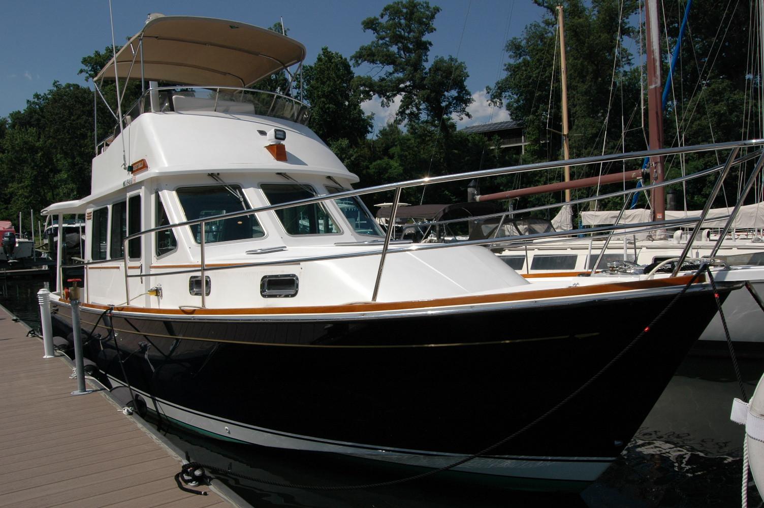 2006 Sabre 36 Flybridge Sedan docked at marina, featuring sleek design and spacious flybridge.