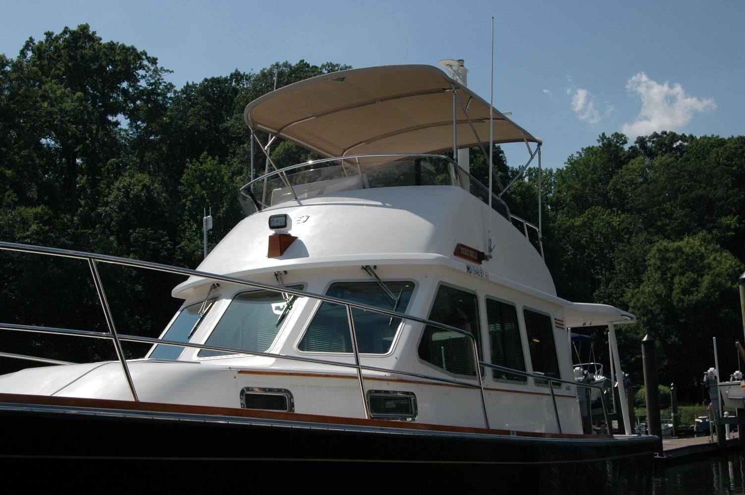 2006 Sabre 36 Flybridge Sedan docked, featuring sleek design and spacious flybridge.