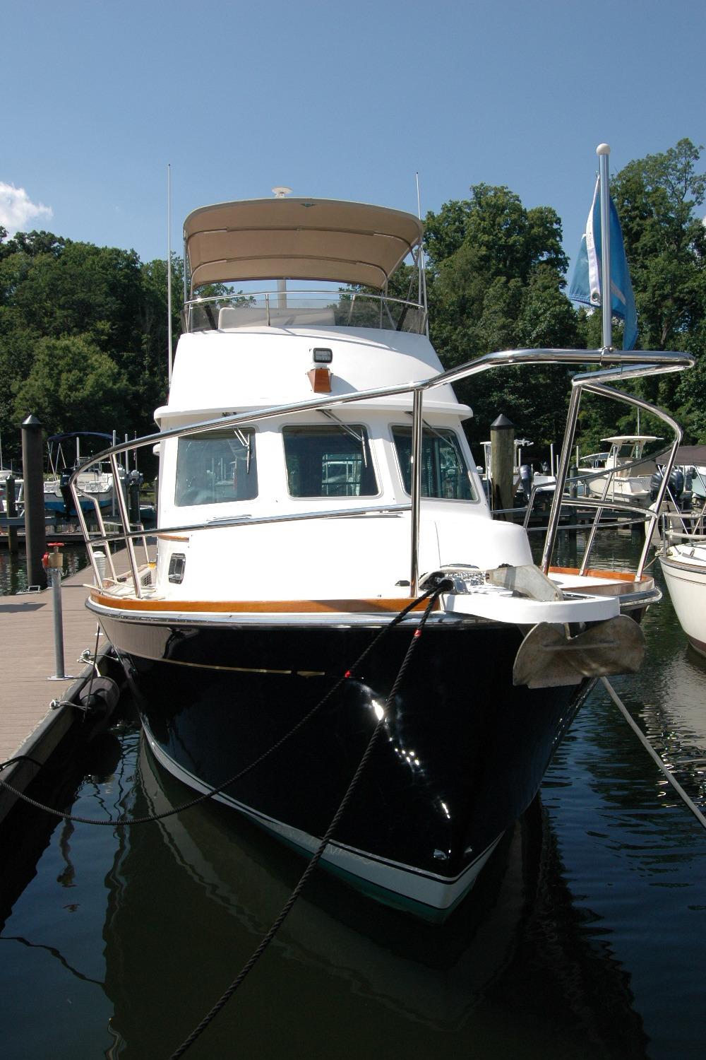 2006 Sabre 36 Flybridge Sedan docked at marina, surrounded by trees and boats.
