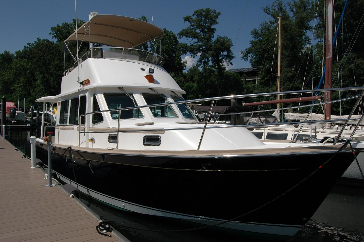 2006 Sabre 36 Flybridge Sedan docked, featuring sleek design and spacious flybridge.