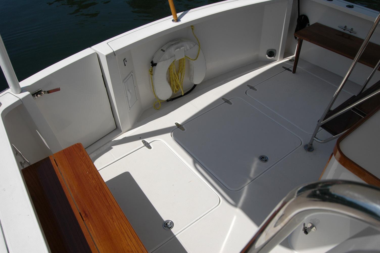 2006 Sabre 36 Flybridge Sedan deck with wooden seating and life preserver.