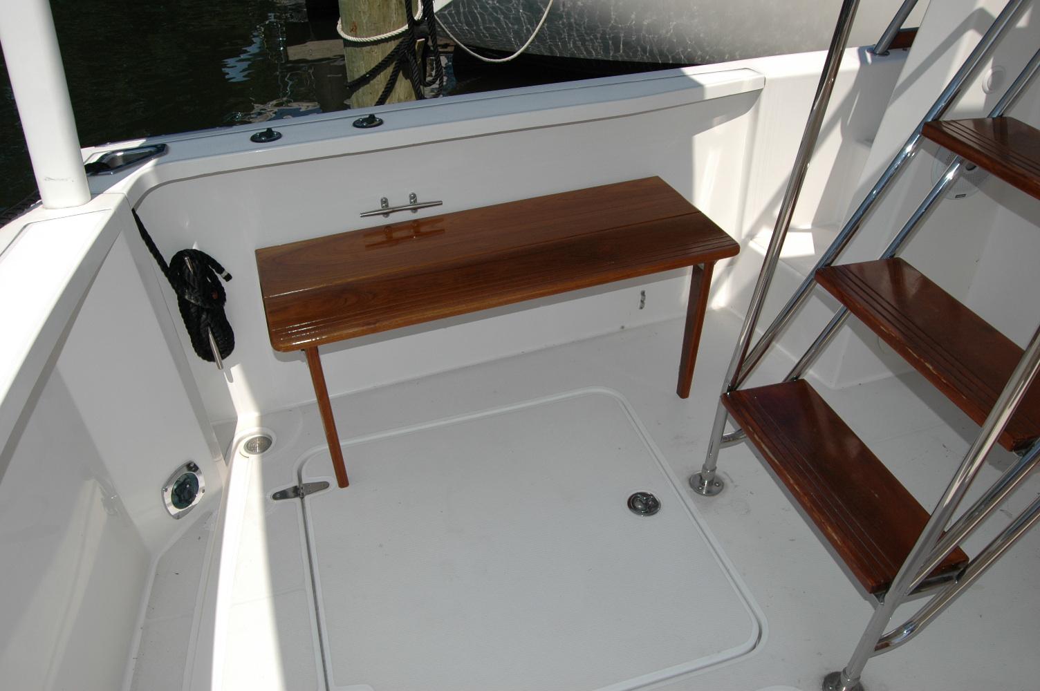 2006 Sabre 36 Flybridge Sedan interior with wooden bench and stairs.