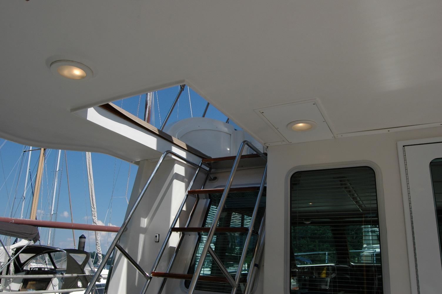 2006 Sabre 36 Flybridge Sedan interior with stairs and windows, showcasing sleek design.