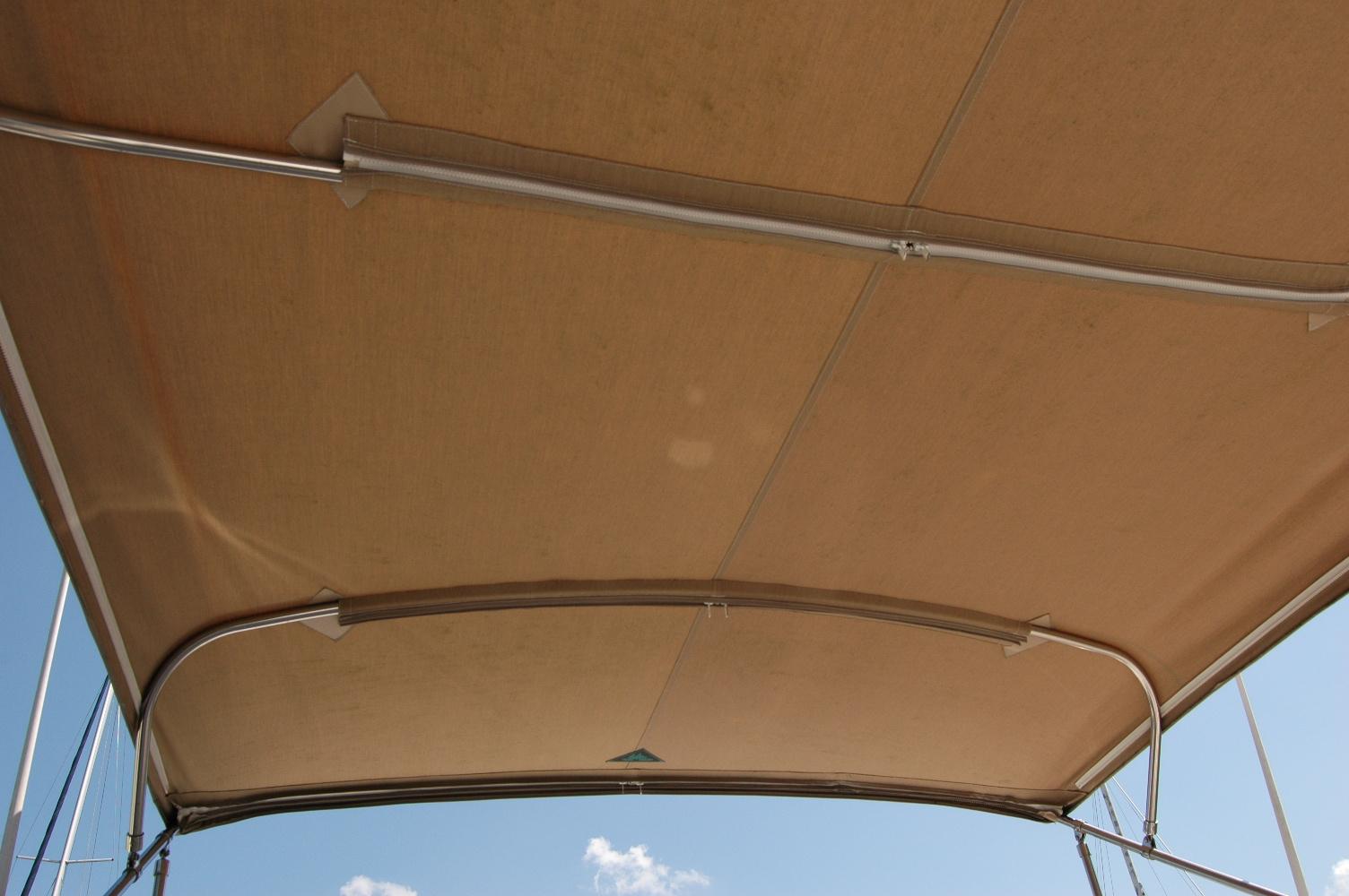 Bimini top of 2006 Sabre 36 Flybridge Sedan against blue sky.