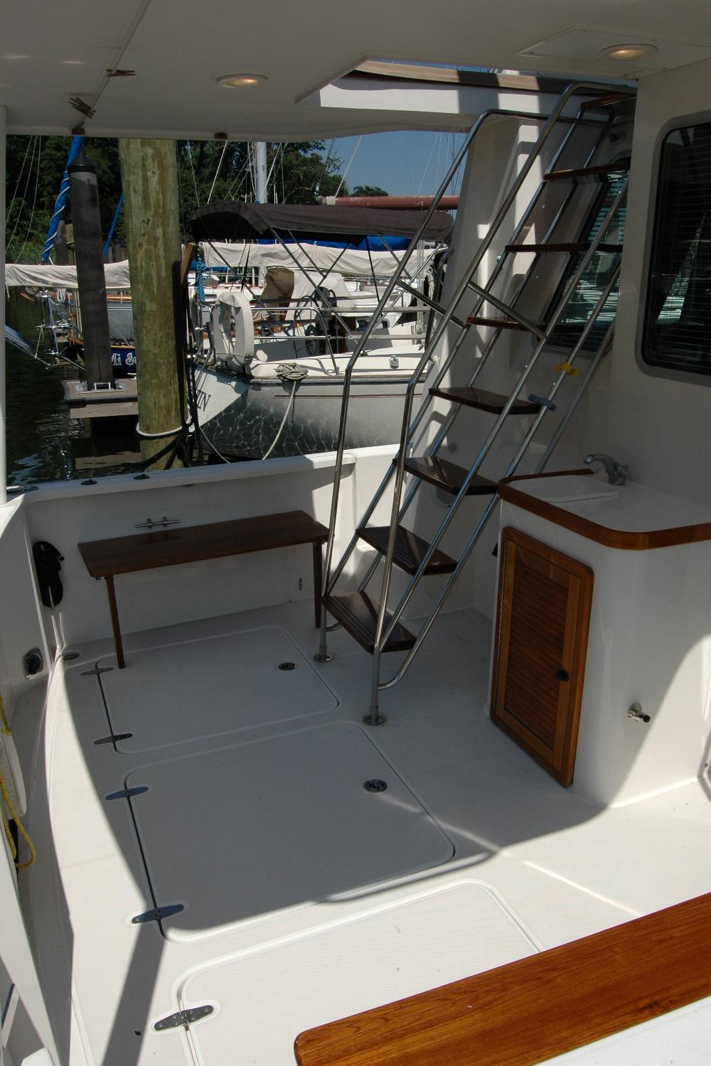 2006 Sabre 36 Flybridge Sedan boat deck with ladder and seating area.