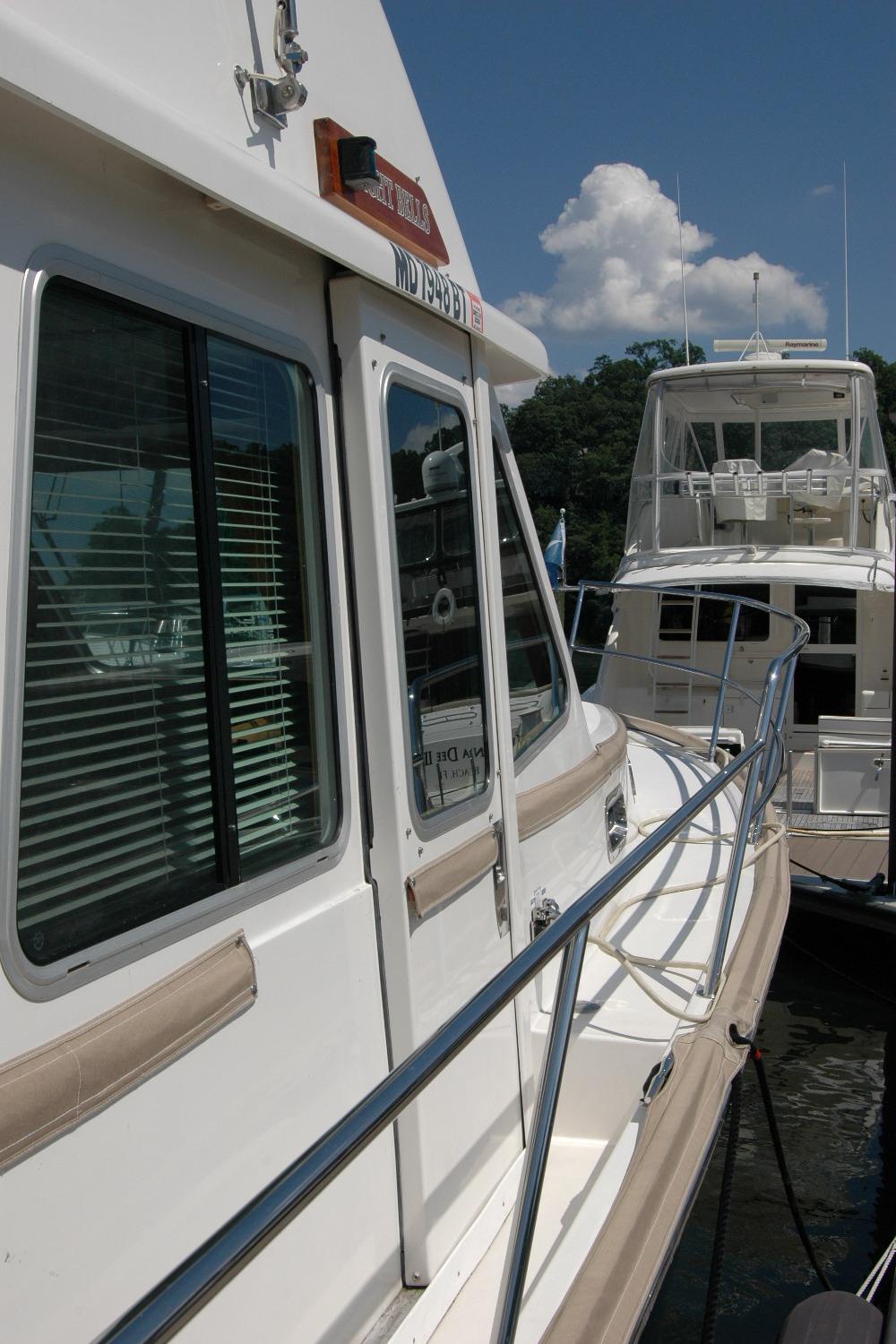 2006 Sabre 36 Flybridge Sedan docked, showcasing sleek design and spacious deck.